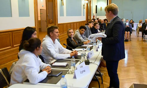 Louis Randoux conseiller municipal remet un sweet-shirt blanc a des membres du conseil municipal des jeunes